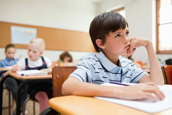 Thinking student sitting at his desk