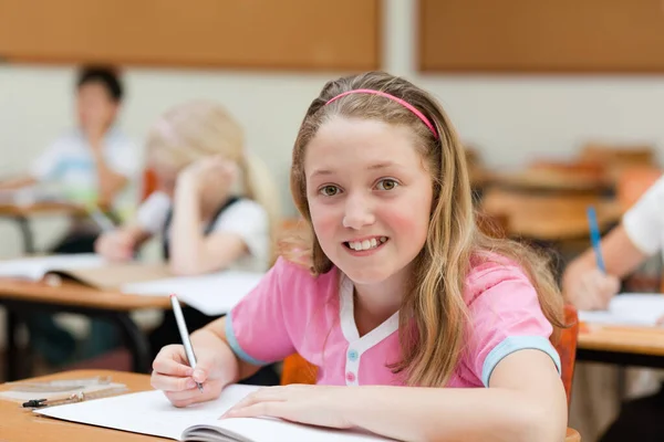 Smiling Female School Child Her Desk —  Fotos de Stock
