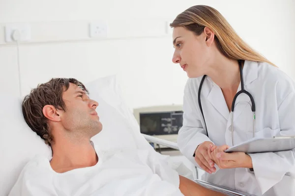 Seriöse Ärztin Gespräch Mit Ihrer Patientin Die Krankenhausbett Liegt — Stockfoto