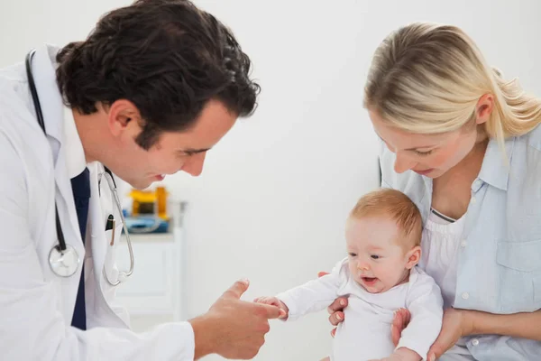 Baby Grabbing Doctors Finger Stock Photo