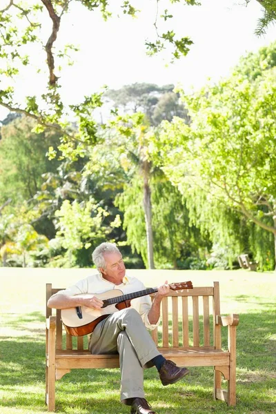 Man Playing Guitar His Eyes Closed Sits Bench Stock Photo