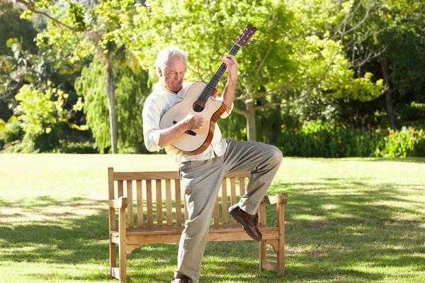 Man Playing Guitar Leg Raised Front Bench Royalty Free Stock Photos