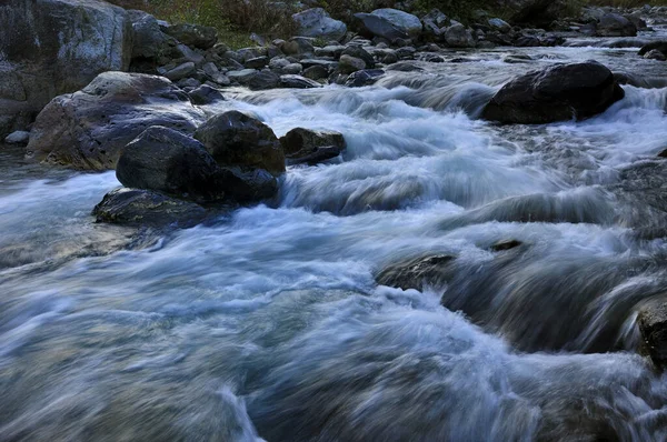 Reshi River water flowing on rocks at Dusk, at Reshikhola - a popular tourist spot in Sikkim, India