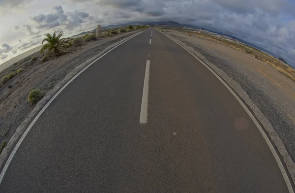 Long Empty Desert Road on a Cludy Day