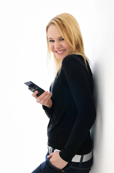 Blond Smiling Teenage Girl Holding Mobile Phone White Background — Stockfoto