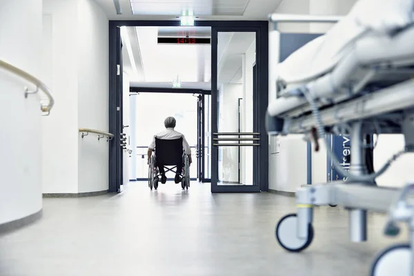 wheelchair in hospital corridor with door