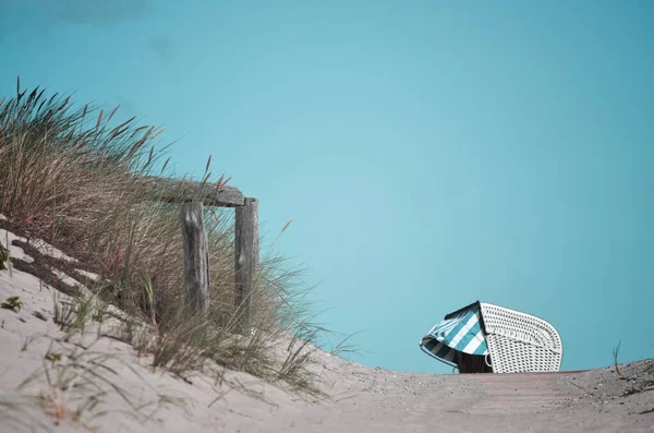 passage to the beach on the baltic sea with a beach chair