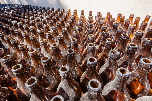 Glass Bottles Stacked Outdoors Alongside Wall Gathering Dust Detail Close — Stock Photo, Image