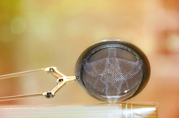 close up of a silver pocket lamp on a blurred background