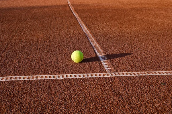 tennis ball on clay court