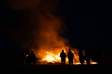 silhouettes of people in frontof big easter fire clipart