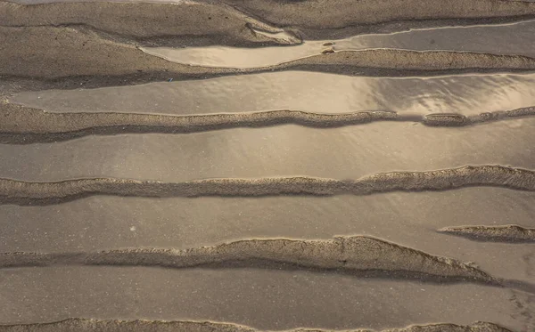 Close Tiro Uma Praia Areia Com Padrões Onda Deixados Pelo — Fotografia de Stock