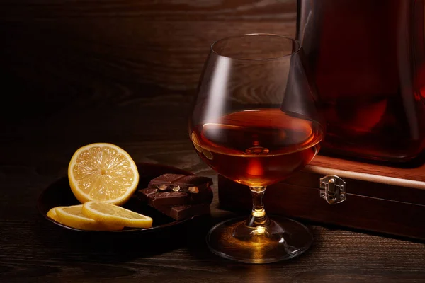 Still Life Bottle Cognac Glass Cognac Plate Pieces Lemon Chocolate — Stock Photo, Image