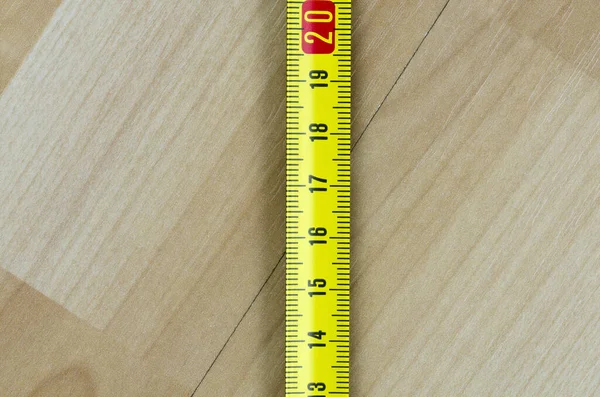 Yellow Measure Tape Rolled Out Old Laminate Floor — Stock Photo, Image