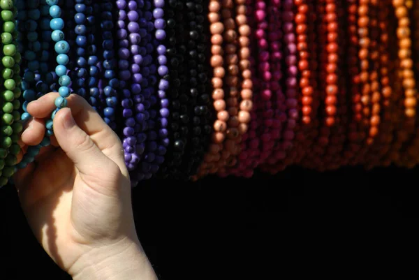 Close Woman Hand Holding Black Beads — стоковое фото