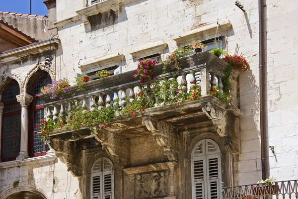 Balcony with flowers on old house