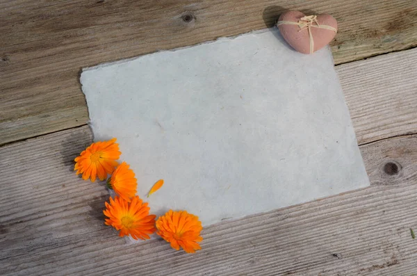 Handmade paper heart flowers old wood background