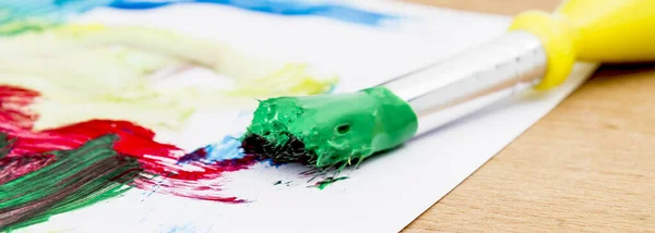 Green Paint Paint Brush Paper Wooden Table Stock Picture