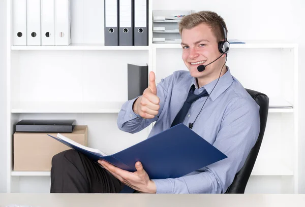 Young Smiling Businessman Headset File Folder Sits Desk Office Points — Stock Photo, Image