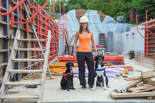 Young woman with construction helmet inspects construction site