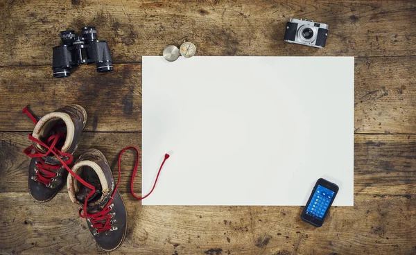 flatlay hiking from above with hiking shoes,shield and paper white