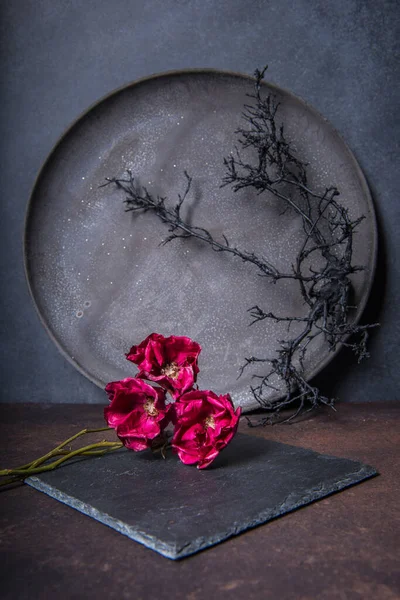 still life with roses and rose on the wooden table