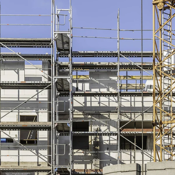 Scaffolding with fall protection in front of new building