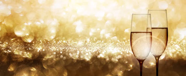 Champagne with festive gold background and shiny bokeh effects for a wedding