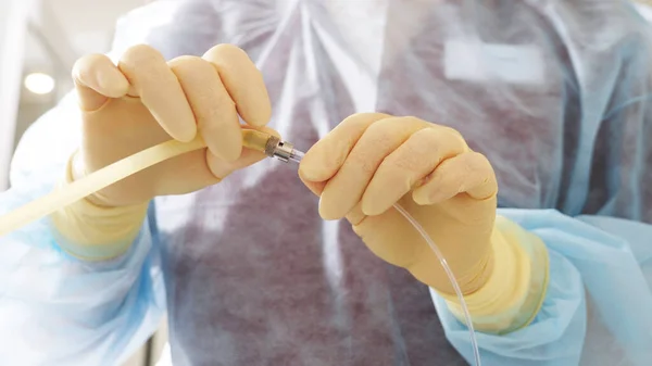 Hands of the doctor in protective gloves before manipulations of artificial insemination. Reproductive technologies. The problem of getting pregnant.