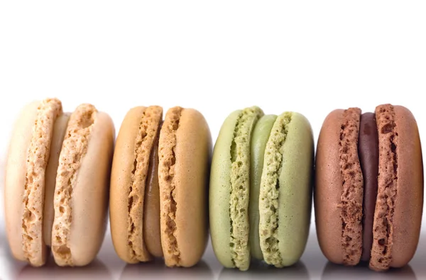 Vier Macarons Hintereinander Auf Weißem Hintergrund — Stockfoto