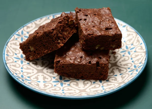 Pieczone Kwadratowe Kawałki Ciasta Czekoladowego Orzechami Brownie Leżą Okrągłym Talerzu — Zdjęcie stockowe