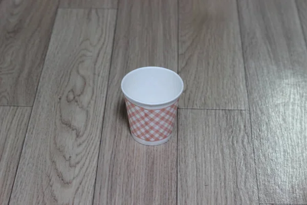 一次性玻璃杯放在木制地板上 木制地板上的一次性纸杯 — 图库照片