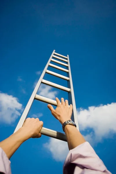 Low Angle Businessman Climbing Ladder Royalty Free Stock Photos