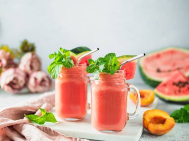Freshly Blended Watermelon and Peach Smoothies in mason jar and metal straw. Copy space for text or design. clipart