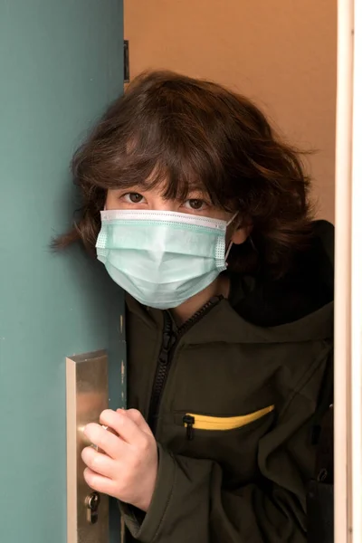 Boy Surgical Mask Looks Out Ajar Door Antivirus Protection — Stock Photo, Image