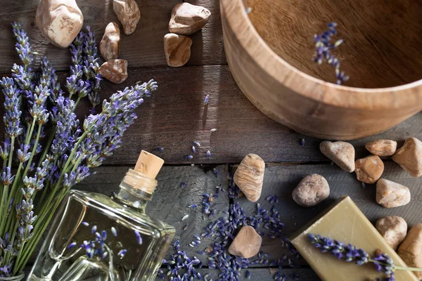 Decoration for a lavender aromatherapy. Atmospheric flat lay photography on dark rustic wood with short deep of field.