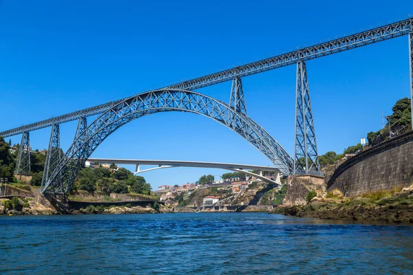 stock image Maria Pia Bridge over the Douro river, Porto, Portugal. View from the water. Wrought iron railway bridge. One of the most popular touristic destinations.