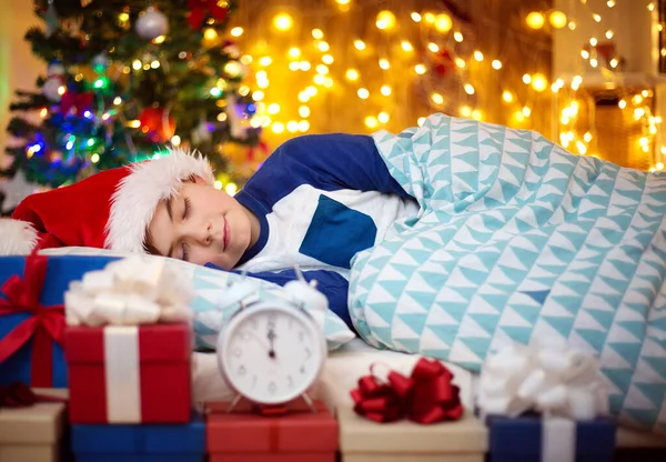 Boy Sleeping Bed Clock Christmas Tree Child Red Hat Home Royalty Free Stock Photos