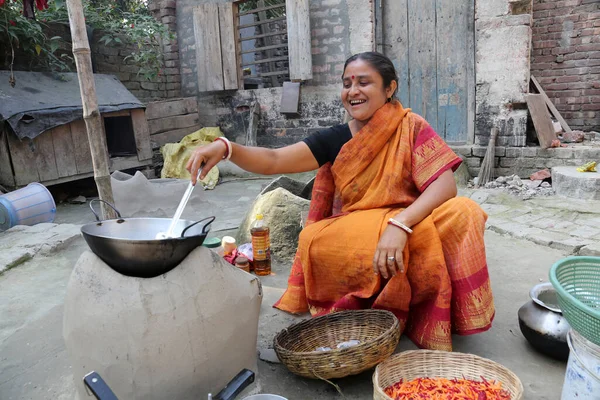 Traditional way of making food on open fire in old kitchen in a village, Kumrokhali, West Bengal, India