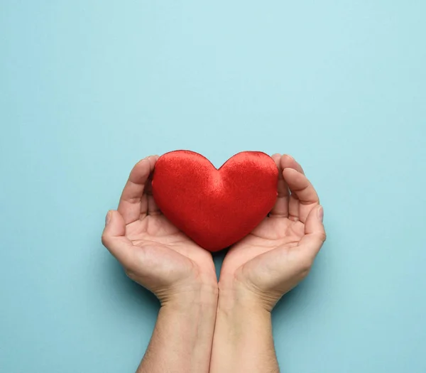 Kadın Elleri Kırmızı Tekstil Kalp Mavi Arka Plan Sevgi Bağışta — Stok fotoğraf