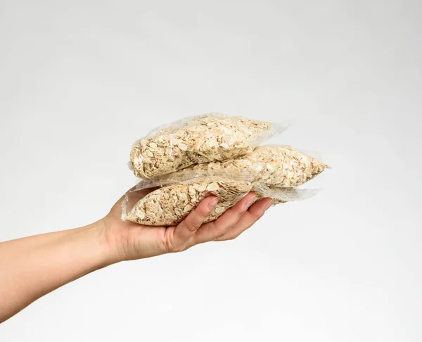 Woman Hand Holds Transparent Bag Oatmeal White Background — Stock Photo, Image