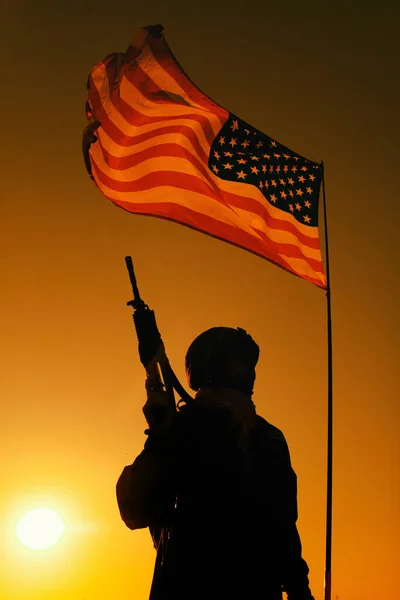美国陆军步兵士兵 特种部队步兵老兵 武装突击步枪的轮廓 他们站在挥动着的美利坚合众国国旗下 背景是日落 — 图库照片