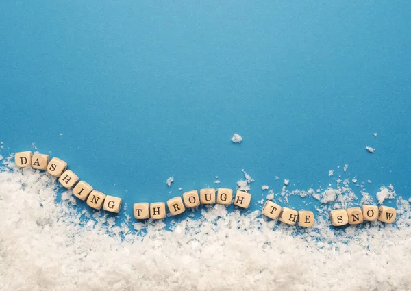 Small Wooden Block Inscription Dashing Snow Snowflakes Blue Background Space — Stock Photo, Image