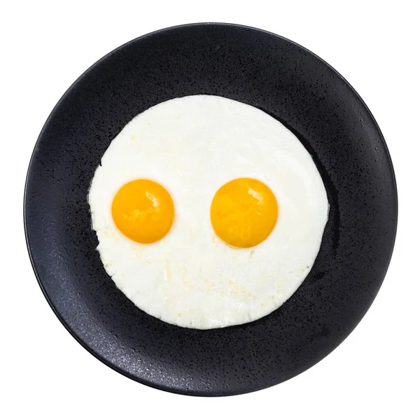 Vista Superior Dos Huevos Fritos Sobre Plato Negro Aislado Sobre —  Fotos de Stock