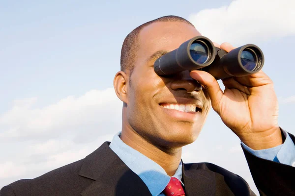 businessman looking through binoculars