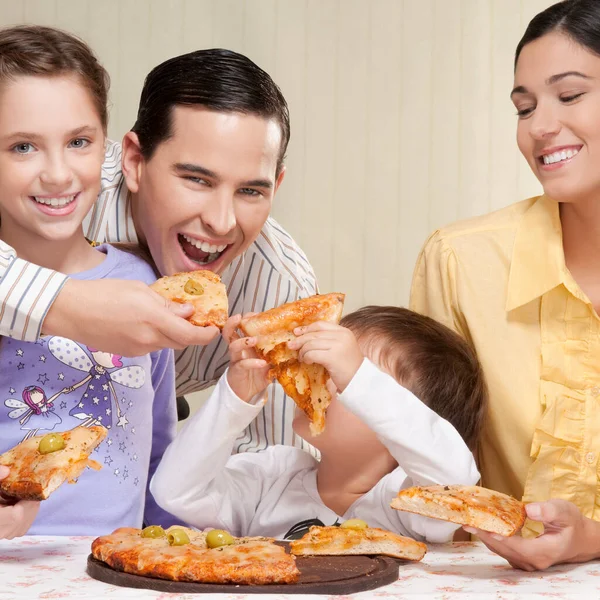 family eating pizza together at home