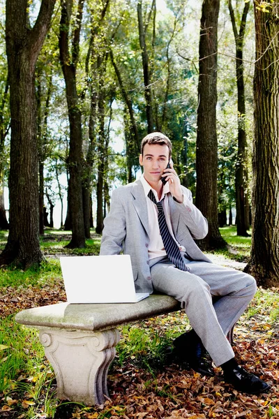 Young Businessman Sitting Bench Talking Phone Stock Photo