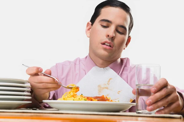 若い男がレストランでサラダを食べる — ストック写真