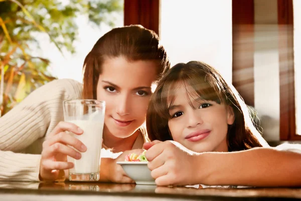 Two Young Girls Having Breakfast Together Stock Image
