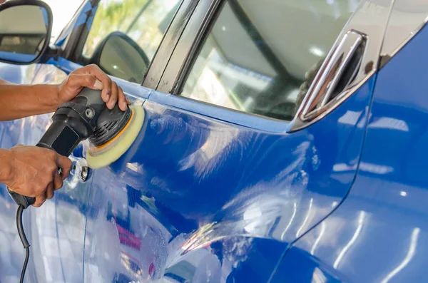 man washing car with a gas can